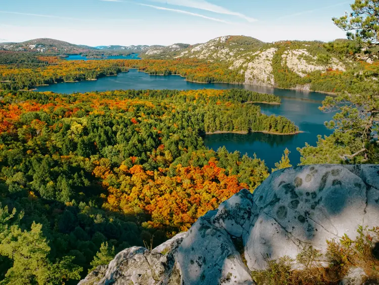 Scenic view of Killarney Provincial Park in Ontario, with bright fall foliage surrounding multiple lakes and white quartzite ridges.