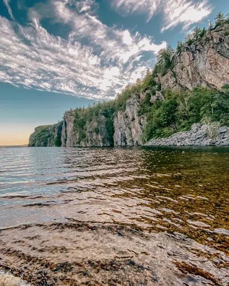 Bon Echo Provincial Park Towering Mazinaw Rock reflecting in the lake on a bright day at Bon Echo Provincial Park.