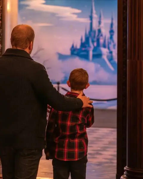 A father and young son view a fantasy exhibit in one of the grand rooms at Toronto's Casa Loma.