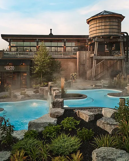 Outdoor pool surrounded by natural landscape at Thermea Spa Village.