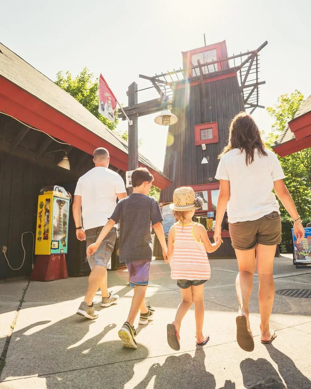 A family walking in the Adventure Village Amusement Park.