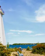 View of Big Tub Lighthouse in Tobermory, Ontario on a sunny day.