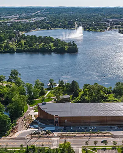 Bird’s eye view of the canoe museum in front of a lake.