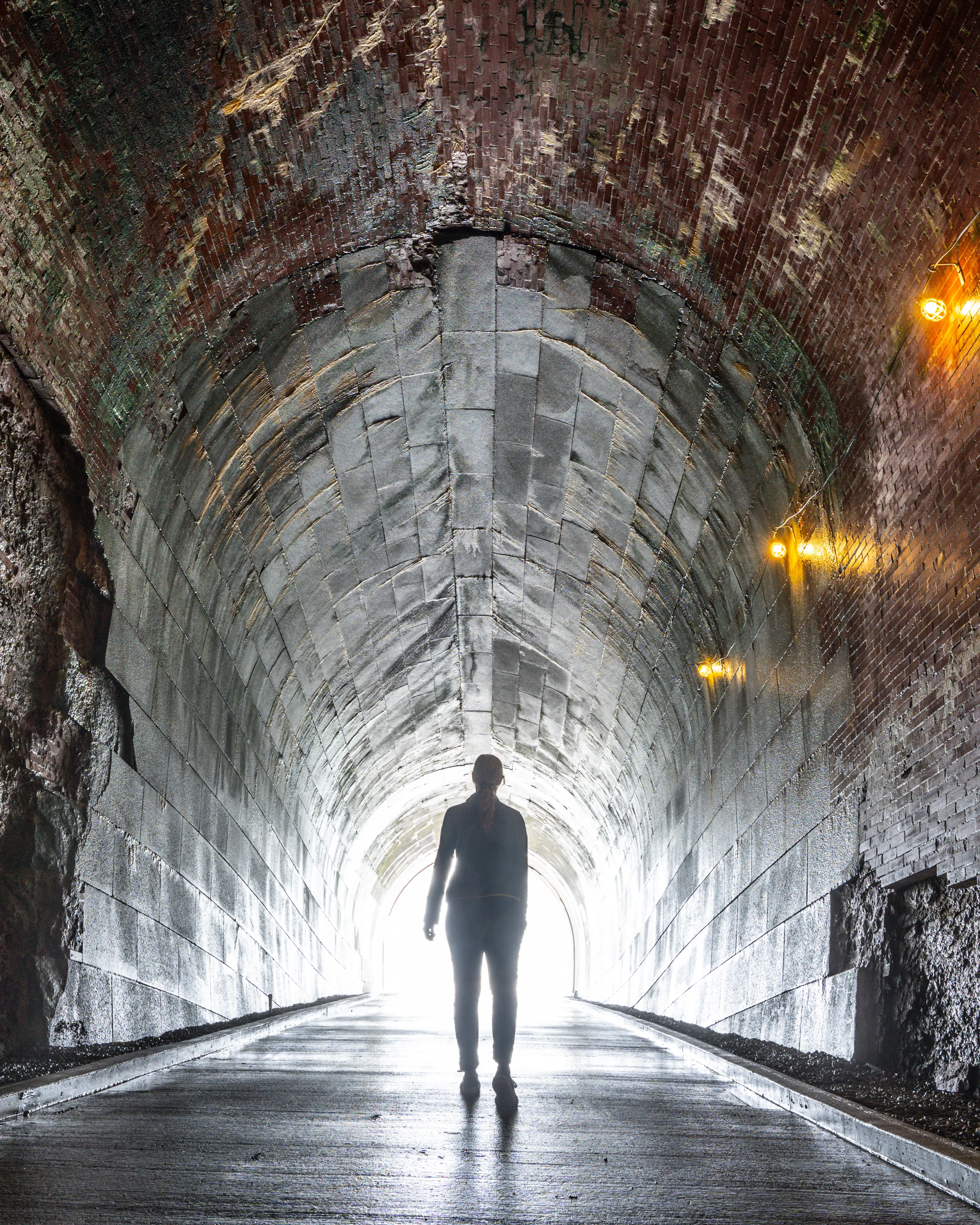A person walking in a tunnel