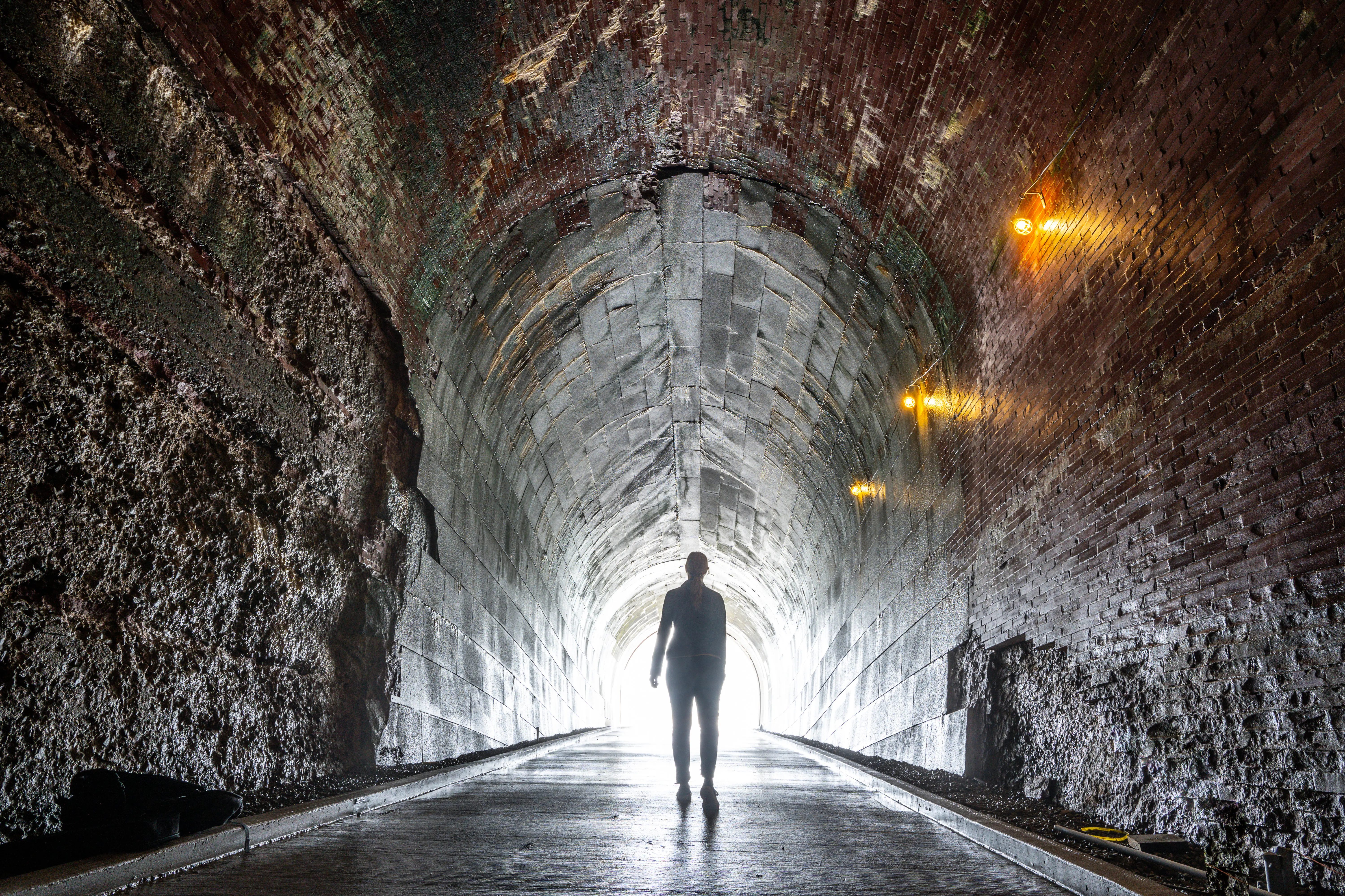 A person walking in a tunnel