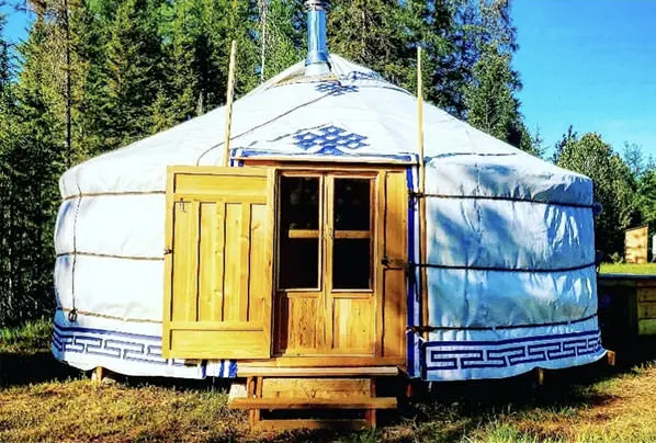 a yurt in a front of many trees