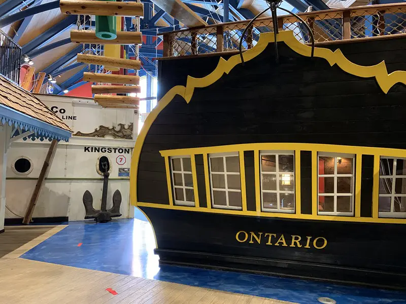 Stern of ferry with upper deck open and lower deck windows revealing interior