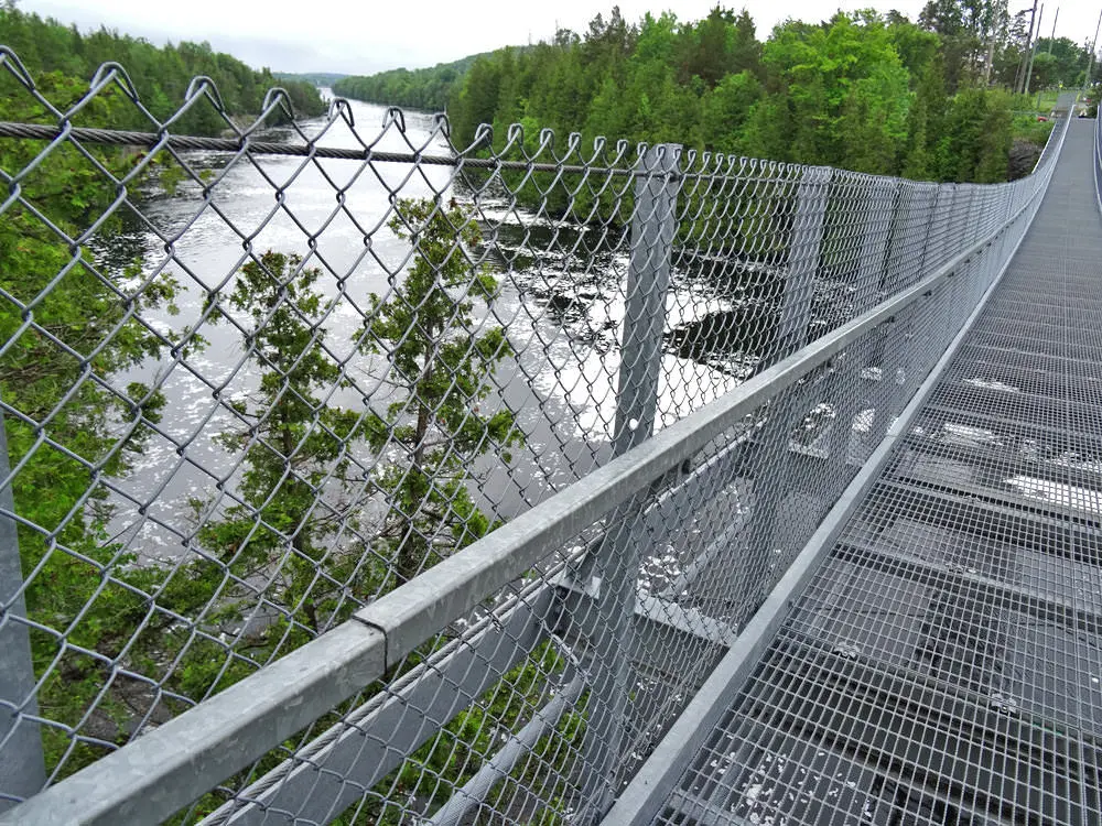Side view of the Ranney Gorge Suspension Bridge over the river.