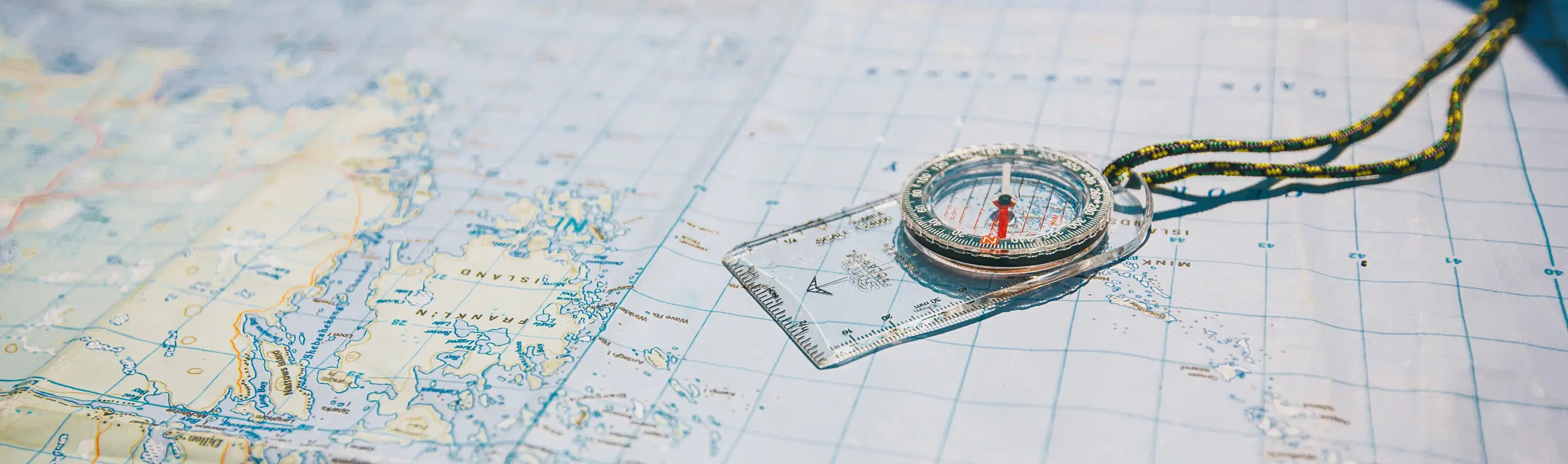 A map of Algonquin Park with a compass resting on top. 