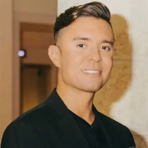 Headshot of Andrew Galloro, appearing relaxed and wearing a dark shirt.