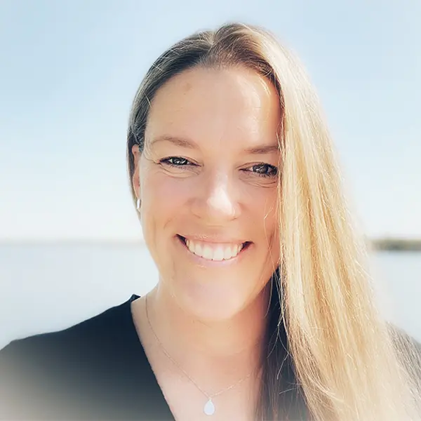 Headshot of Danielle Chretien, smiling and wearing a dark shirt.
