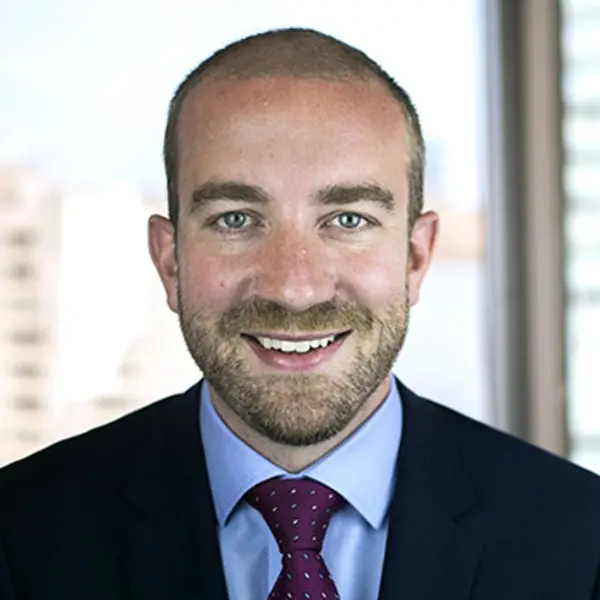 Headshot of Dennis Matthews, smiling and wearing a suit.