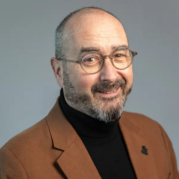 Headshot of Rob Taylor, smiling and wearing a brown suit jacket.