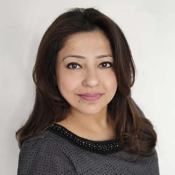 Headshot of Sumeeta Kohli, smiling and wearing a black shirt.