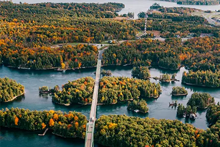 Bridge crossing forested islands with fall colours in the 1000 Islands region of Ontario.
