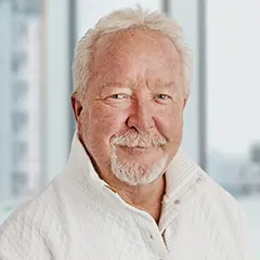 Headshot of Ian McMillan, smiling and wearing a white shirt