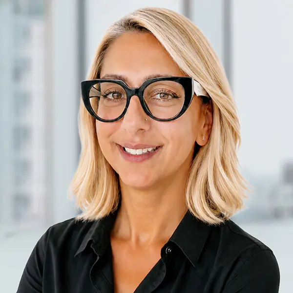 Headshot of Maria Mavridis, smiling wearing a black shirt.