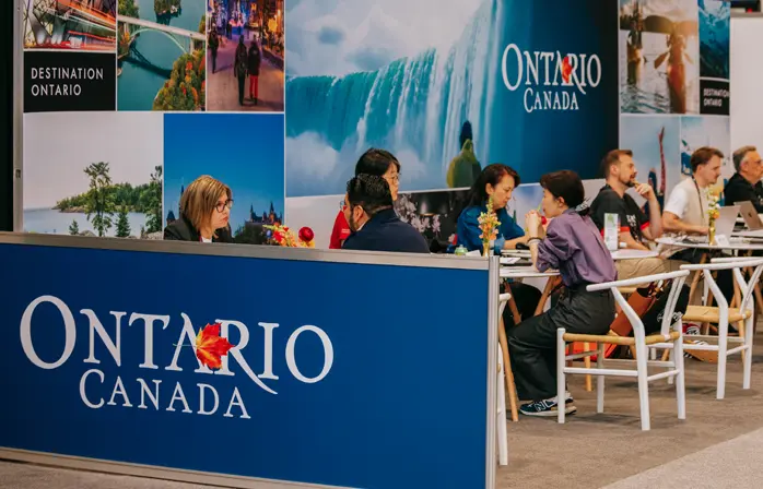 Destination Ontario tourism booth at a trade show, featuring Ontario travel imagery and branding.
