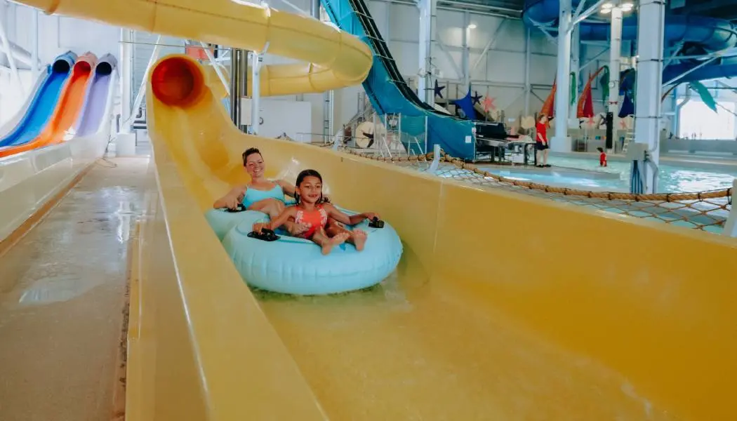 A mother and daughter enjoy a waterslide ride in innertubes at Adventure Bay Waterpark in Windsor.