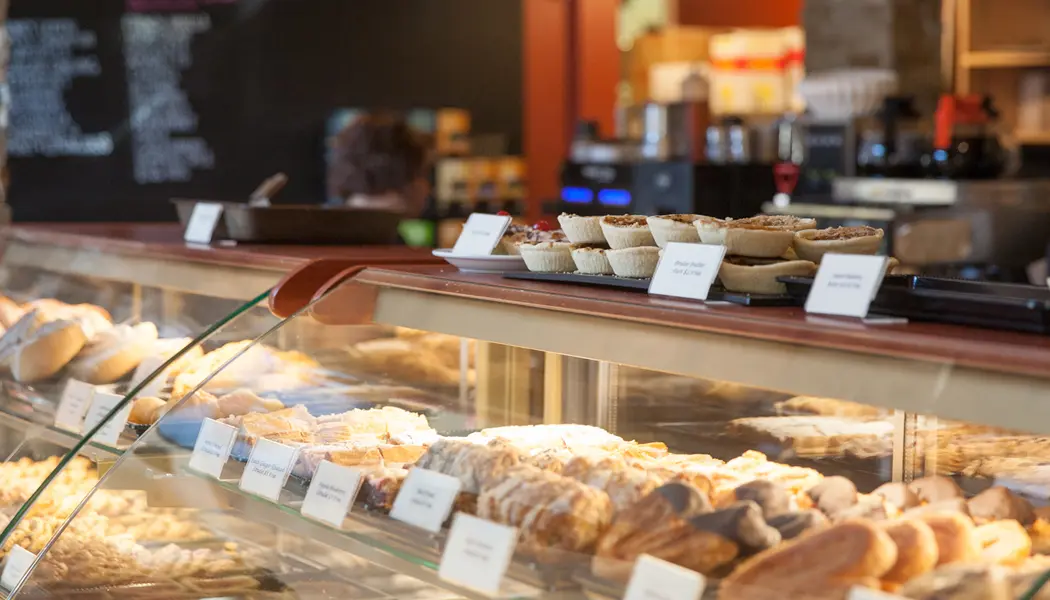 En la barra delantera del café Annina's en Goodwood se exhiben diversos postres y pasteles en una vitrina.