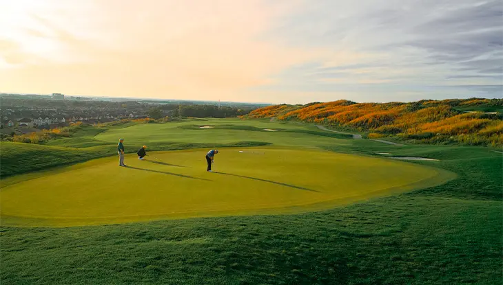 Three golfers playing a round on BraeBen Golf Course in Mississauga in the fall season.