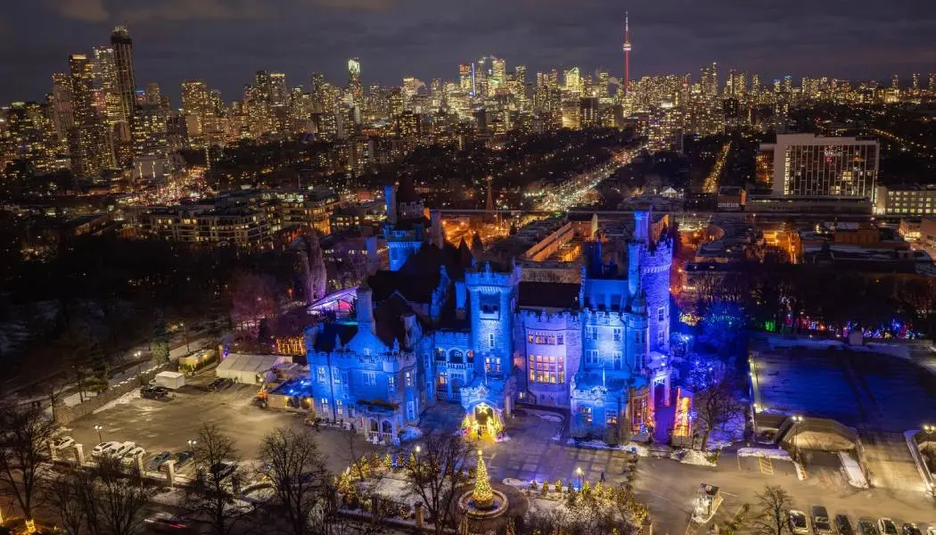 The famous Casa Loma castle in downtown Toronto is illuminated in a magical blue light in the evening during the holiday season.