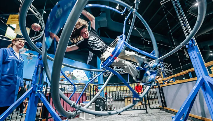 Large mechanical gyroscope exhibit inside a science and technology museum.