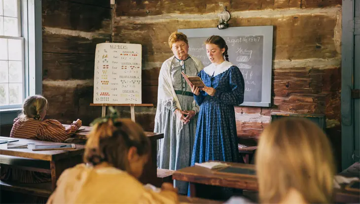 Historical classroom reenactment at Westfield Heritage Village featuring period-costumed educators and students.