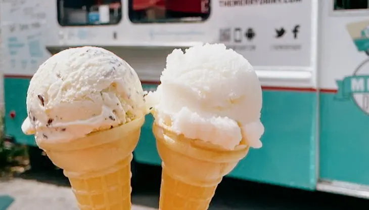 Two ice cream cones in front of a food truck