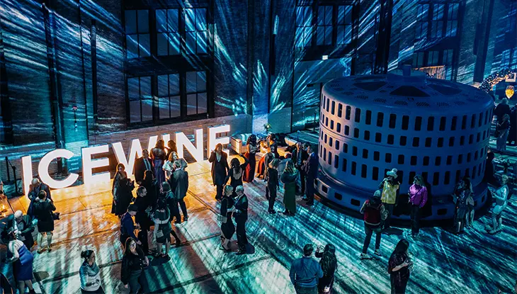 Guests gather at an illuminated icewine event with dramatic strobe lighting.