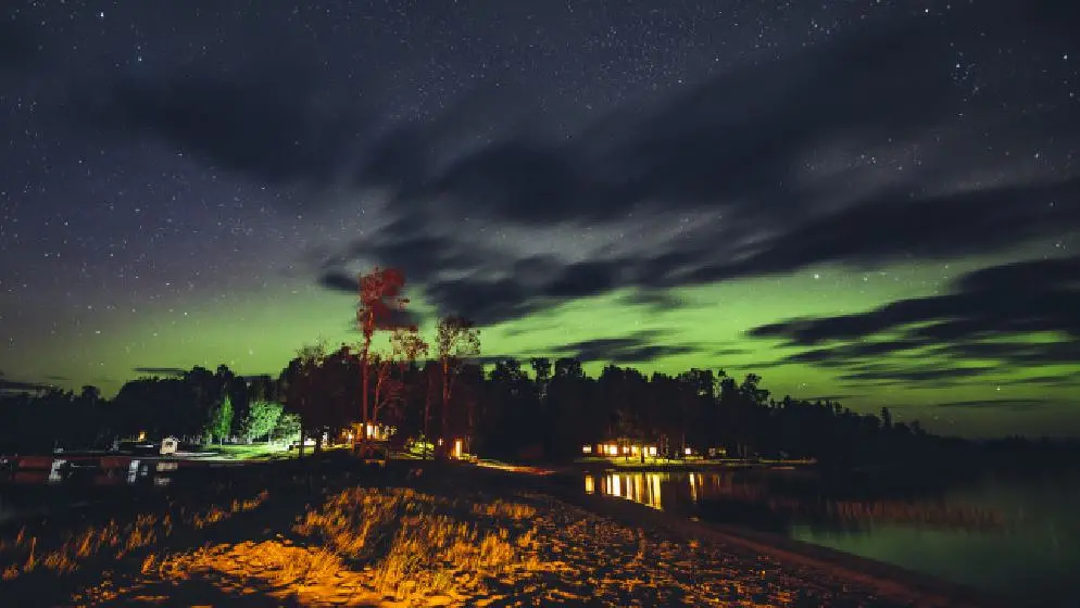 Green and blue colours of the Northern Lights over a small community in Northern Ontario