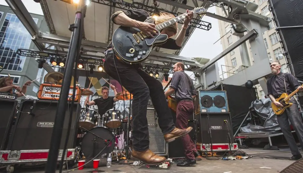 A live music band delivers an energetic outdoor performance during NXNE in Toronto.