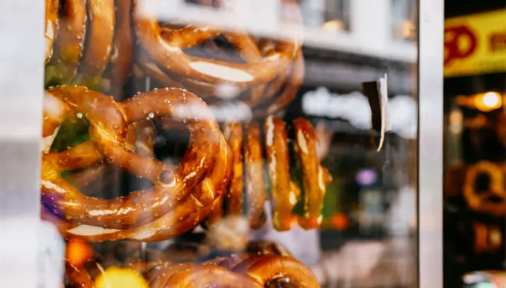 Pretzels on display in a glass case.