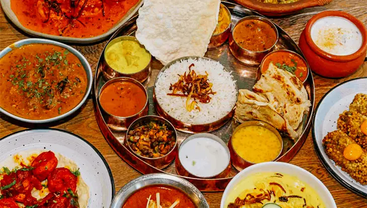 Indian food spread with curries, rice and naan served at Thali in Ottawa.