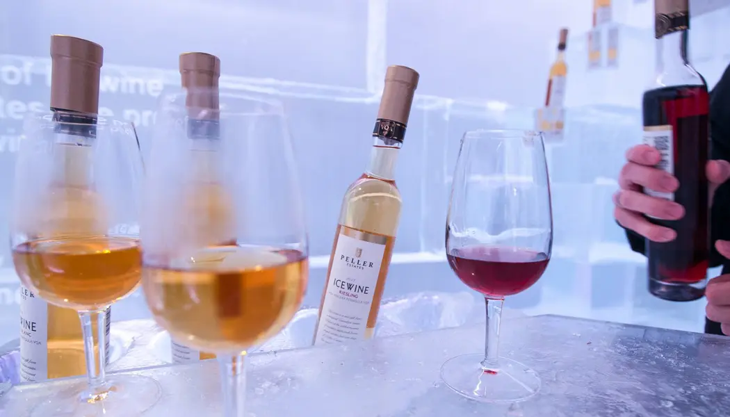 Wine bottles and glasses sit on a frozen bar during an Icewine tasting at Peller Estates Winery.