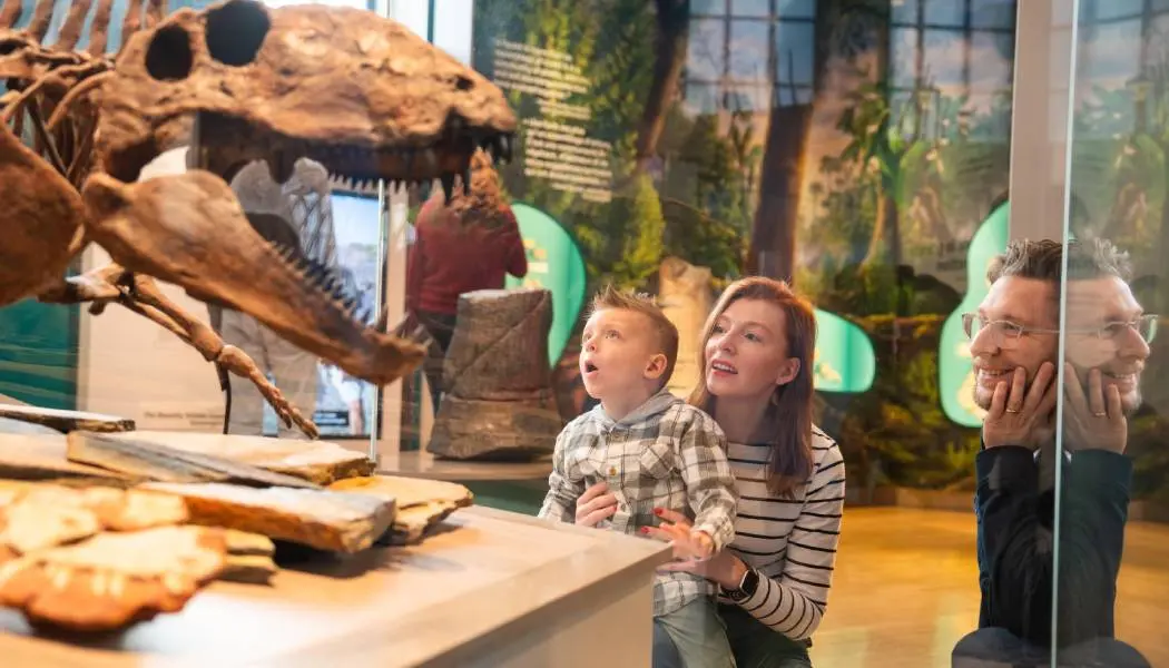 A family with a young boy admires a dinosaur skeleton exhibit at the Royal Ontario Museum in Toronto.