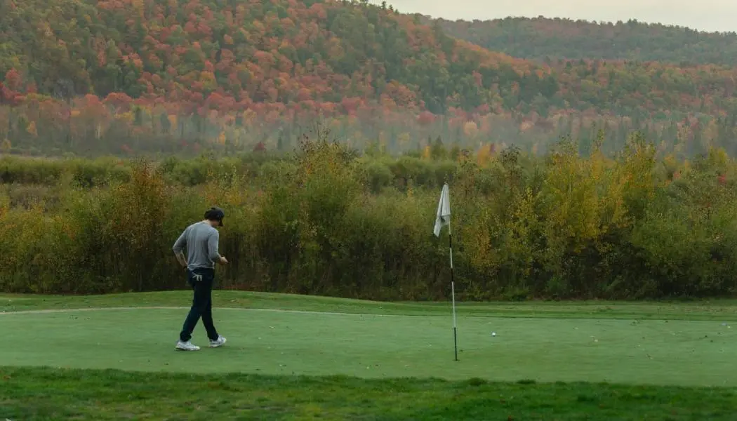 A man walks on a scenic golf course in Sault Ste. Marie.